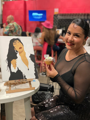 a lady with selena painting and a cupcake
