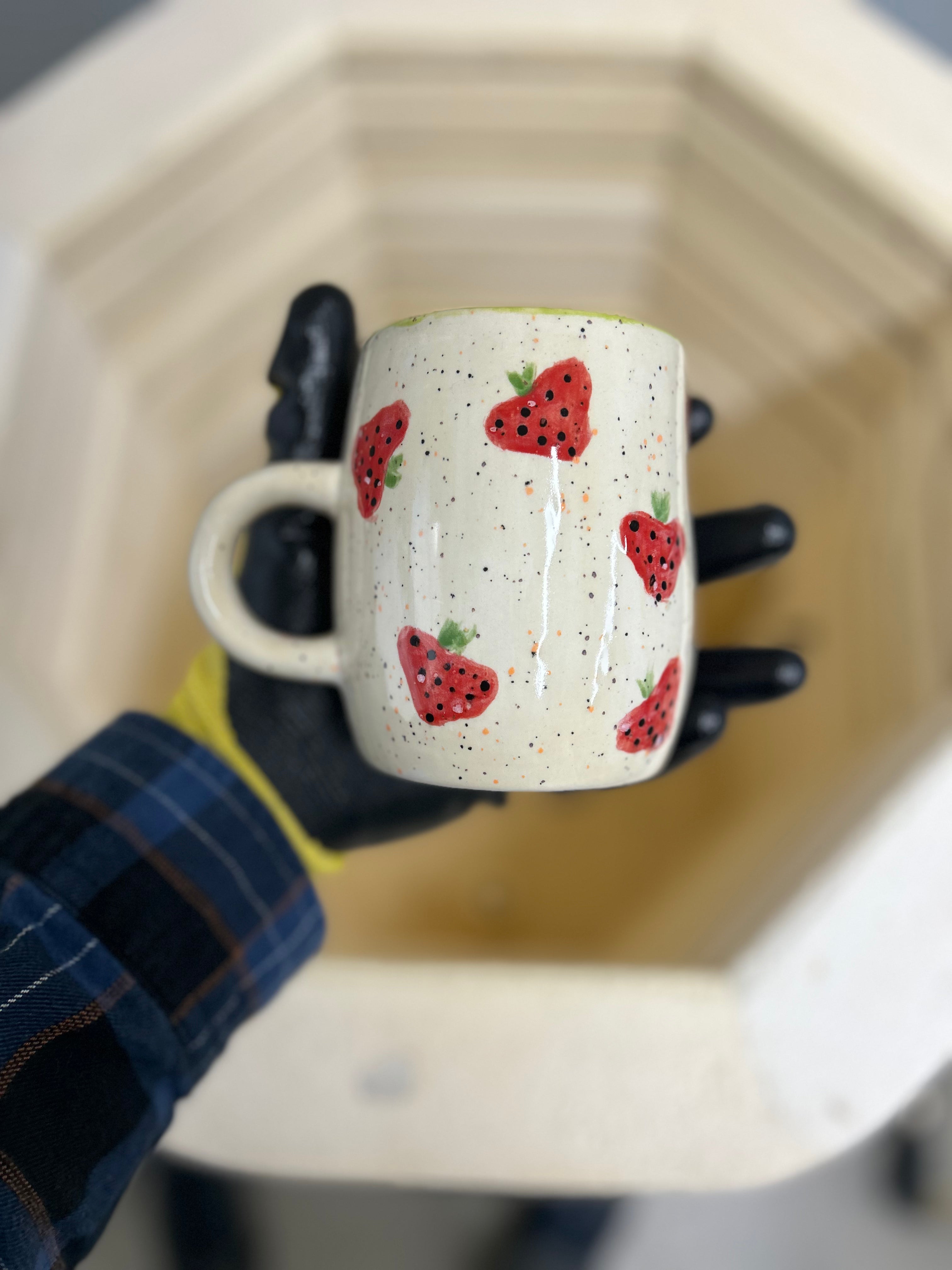 his is a mug with strawberry print
