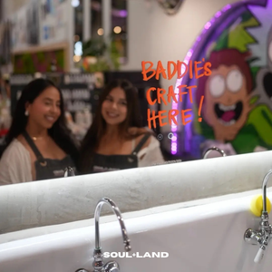 two young girls taking a picture at soulland lab with the mirror that says baddies craft here. 